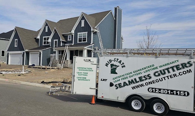 MidState Seamless Gutters Trailer at a Blue Home